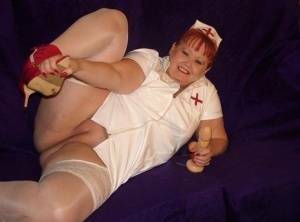 Mature redheaded nurse Valgasmic Exposed exposes herself during dildo play on modelies.com