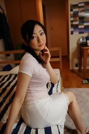 Slender mature Japanese woman Emiko Koike bends over to pose in white dress - Japan on modelies.com