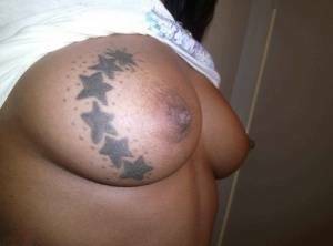 Ebony amateur takes self shots of her big tattooed boobs and bald vagina on modelies.com