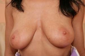 European babe freeing big MILF tits from uniform before masturbating on modelies.com