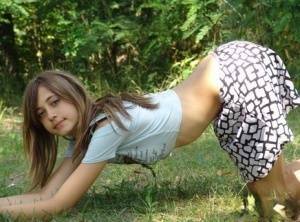 Shapely young teen in tiny t-shirt and short skirt posing outdoors on modelies.com