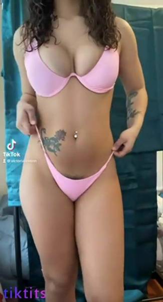 Girl in a swimsuit for TikTok sexy chic twists her tight ass on modelies.com