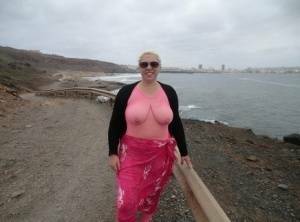 Aged lady Barby looses her big tits from a crotchless bodystocking by the sea on modelies.com