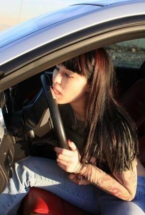Amateur girl Susy Rocks flips the bird while exposing her big tits in a car on modelies.com