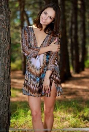 Sweet teen with an ass to die for disrobes for great nude poses in a forest on modelies.com