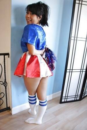 Tiny Asian cheerleader May Lee posing in cute uniform and socks on modelies.com