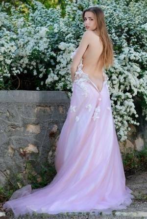 Beautiful girl Elle Tan slips off wedding dress to pose nude in garden on modelies.com