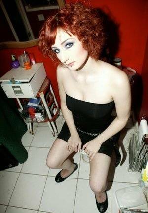 Pale redhead Violet Monroe gets naked in flat shoes while in a bathroom on modelies.com