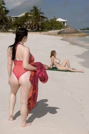 Plump female Christy Mark and her big boobed friend have lesbian sex on beach on modelies.com