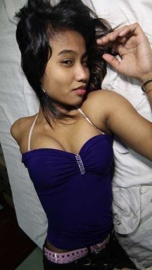 Filipina teen Porn shows her trimmed muff up close after getting nude on a bed on modelies.com
