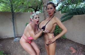 Big titted older women Claudia Marie and Minka kiss outdoors in skimpy bikinis on modelies.com