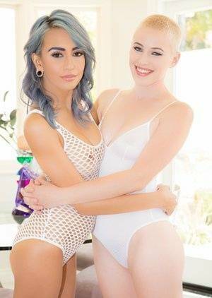 Bisexual female Janice Griffith and her girlfriend give a double blowjob on modelies.com