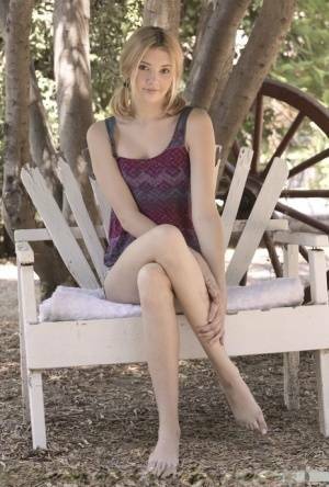 Teen first timer Lena Anderson vaunts her lithe body under a tree outside on modelies.com