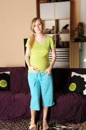 Smiley pregnant amateur with puffy nipples and hairy gash getting naked on modelies.com