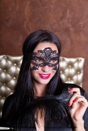 Sexy brunette Leyla Lee removes a mask and robes to pose nude with a feather on modelies.com