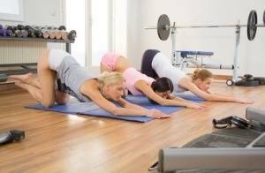 Young girls stretch out on yoga mats before commencing a lesbian threesome on modelies.com