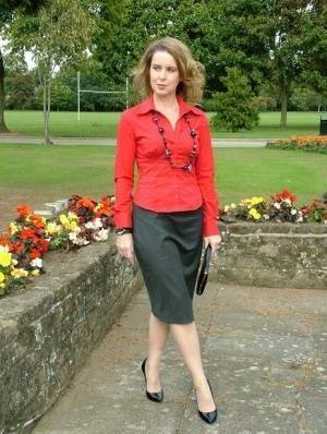 Fully clothed woman steps out of a stiletto heel while visiting a public park on modelies.com