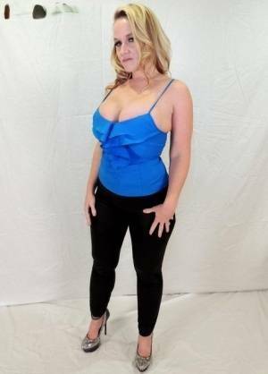 Middle-aged blonde Dee Siren displays her ample cleavage in tight pants on modelies.com