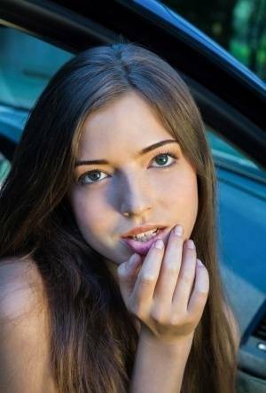Beautiful teen girl models in the nude on passenger seat of car with door open on modelies.com