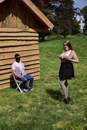 Natural redhead masturbates on a lawn before teasing a masked man on modelies.com