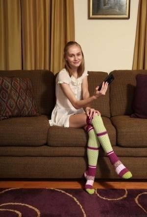 Adorable teen Alicia Williams takes a selfie before getting naked in OTK socks on modelies.com