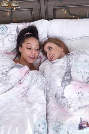 Interracial lesbians lick assholes and pussies on a bed in sport socks on modelies.com